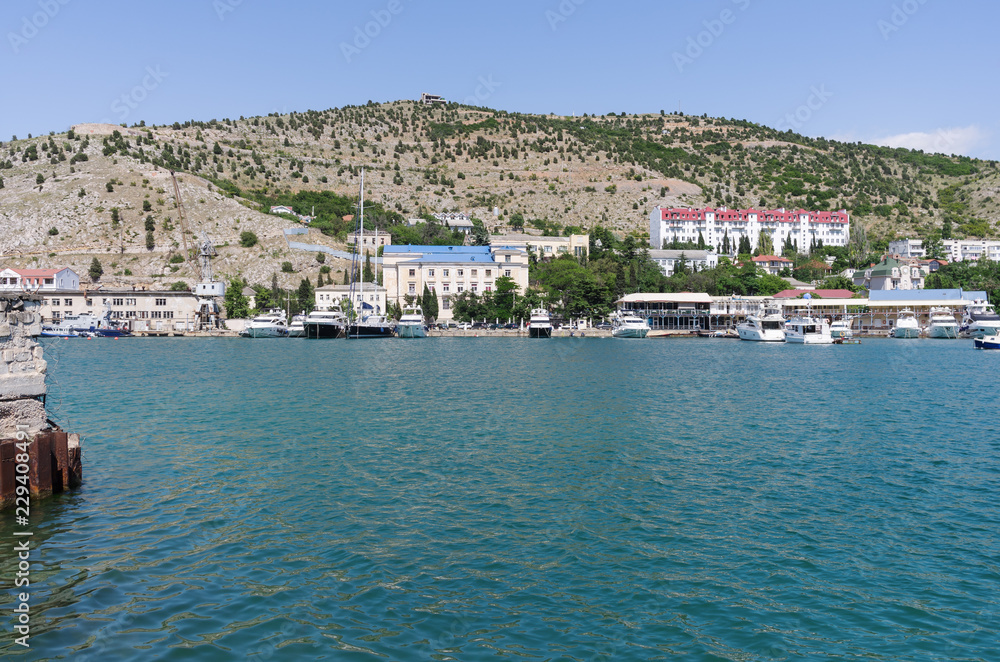 Pier in the sea bay. Russia, Republic of Crimea, Balaclava. 11.06.2018: Pleasure yachts at the marina in Balaklava Bay