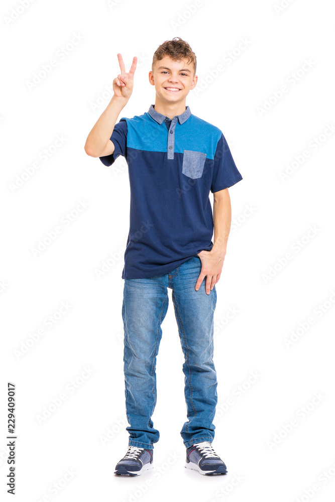 Full length portrait of young caucasian teen boy isolated on white background. Funny teenager making victory gesture. Handsome child looking at camera and smiling. Full length portrait of young caucasian teen boy isolated on white background. Funny teenager making victory gesture. Handsome child looking at camera and smiling.