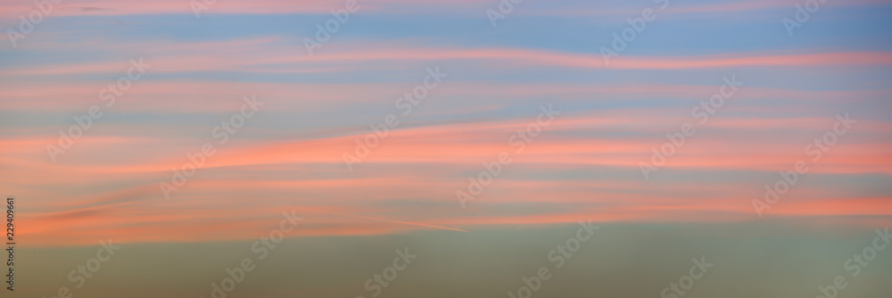 Panoramic view of a beautiful pink sky at sunset with soft clouds