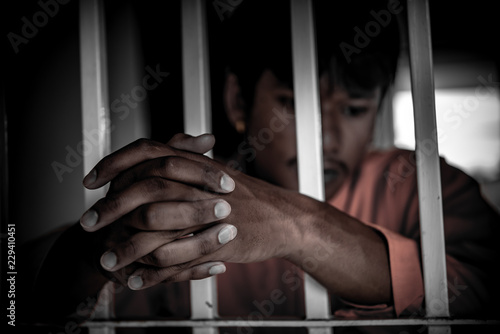Asian Men desperate to catch the iron prison,prisoner concept,thailand people,Hope to be free.