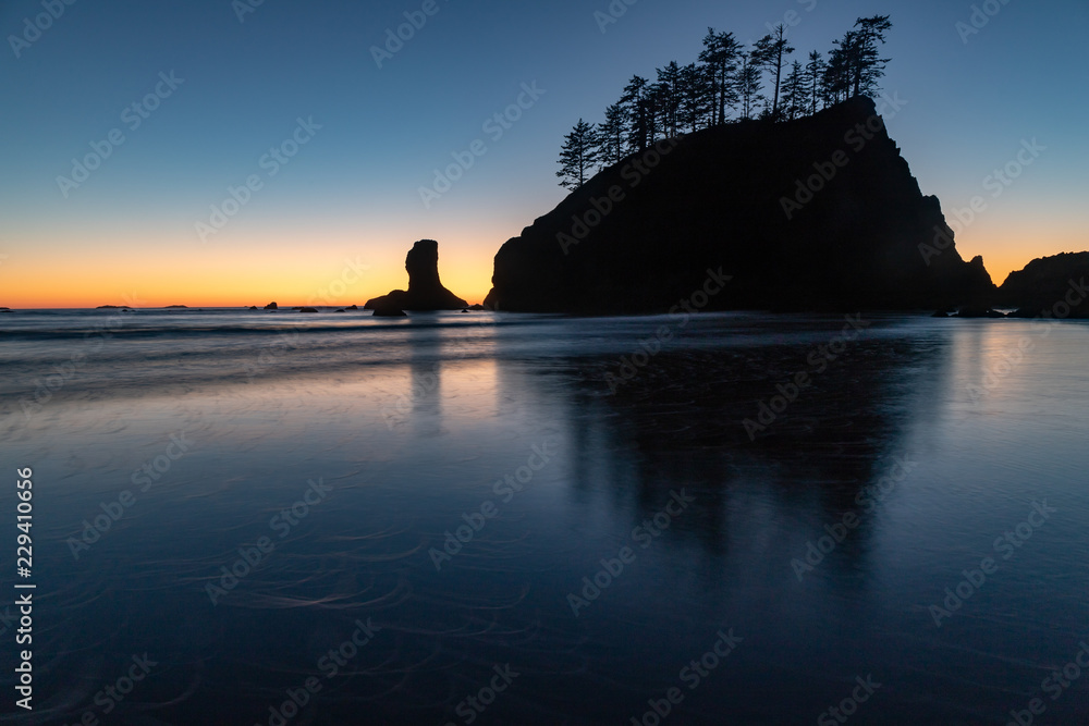 This is a sea stack and it reflection found at second beach at La Push, Washington