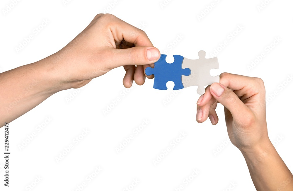 Closeup on Hands Combining Puzzle Pieces Together Closeup on Hands Combining Puzzle Pieces Together