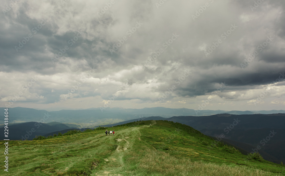 beautiful view of mountains landscape. Chornohora mountain ridge and big group of tourists from slopes of Hoverla mountain