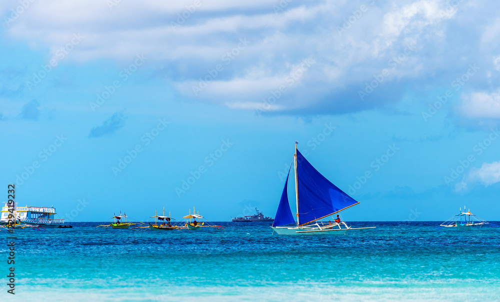 Obraz premium BORACAY, PHILIPPINES - FEBRUARY 28, 2018: View of the sailboat on the background of the sea landscape. Copy space for text.