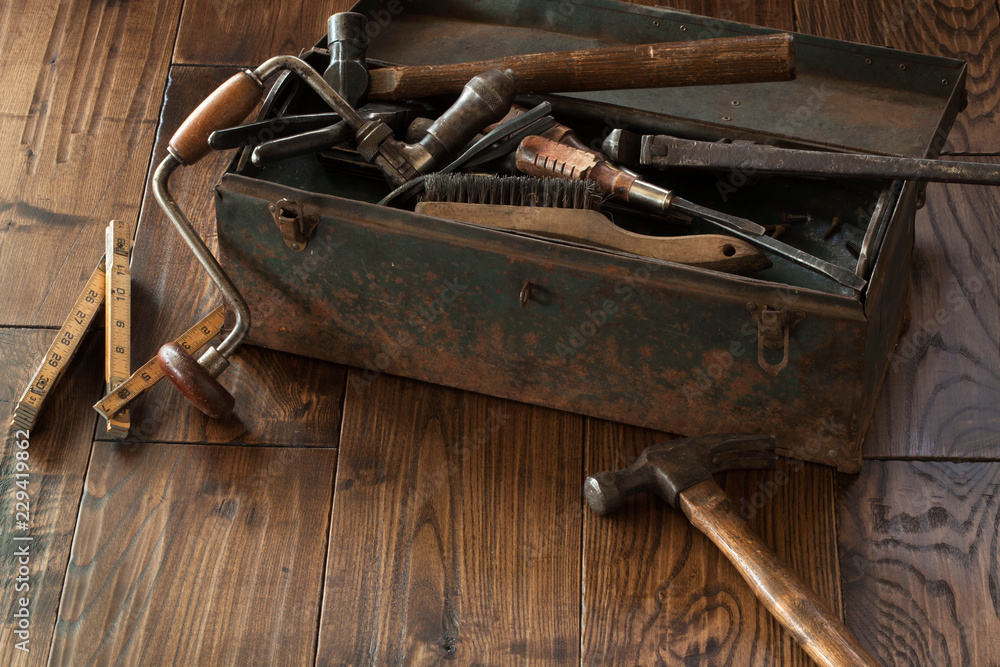 Fototapeta premium Antique tools and toolbox on dark wood surface