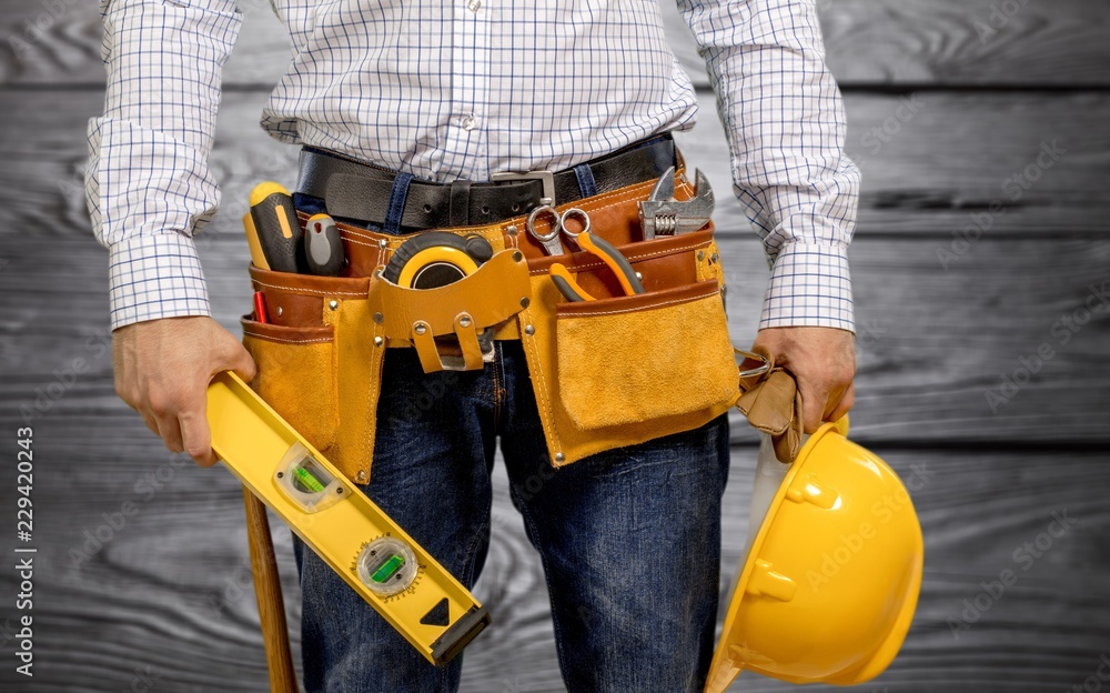 Worker with a tool belt. Isolated over background. Worker with a tool belt. Isolated over background.