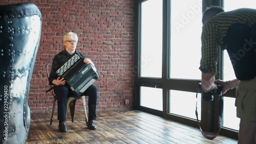 Wallpaper Mural Photographer takes pictures of a musician with an accordion. Home education. Quarantine viral infection COVID 19. Self isolation. Social distance. Online education. Torontodigital.ca