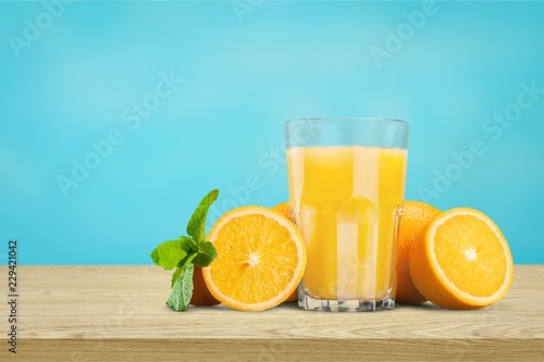 Orange juice and slices of orange on background