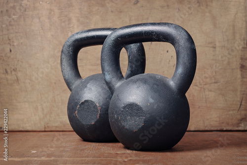 two heavy kettlebell black on wooden background