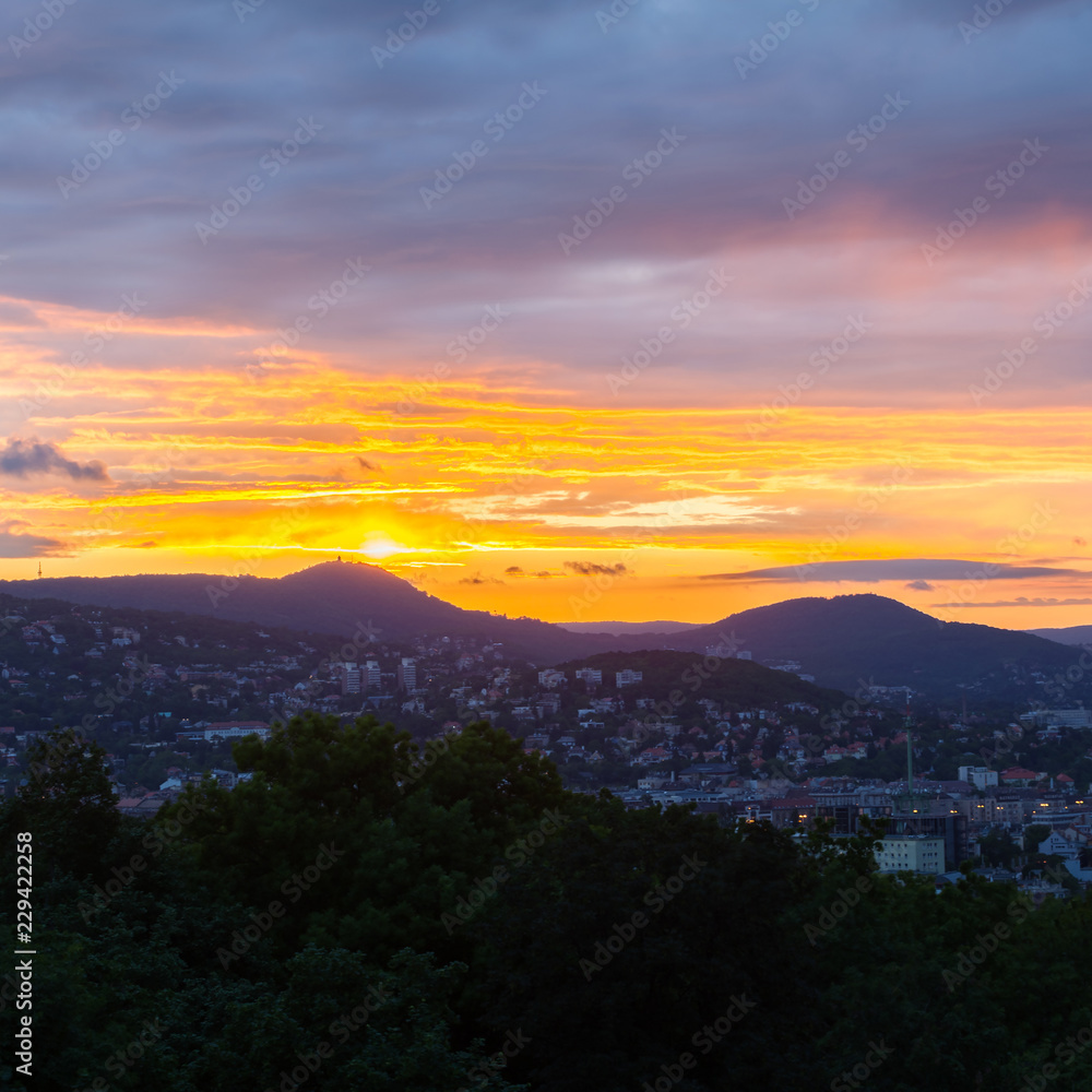 Evening panorama of Budapes from Gellert Hill with a beautiful sunset sky