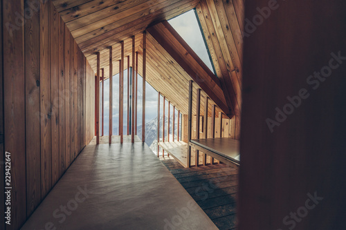 Wooden interior of a free public mountain alpine bivouac shelter. Design architecture interior of a bivi Bivak pod Skuto, Kamnik Savinja Alps, Slovenia.