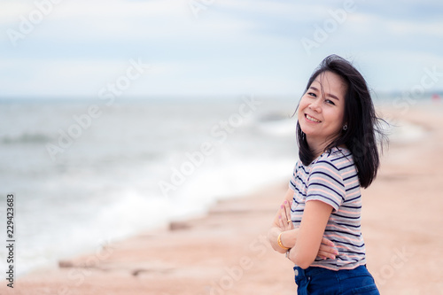 Portrait of asian beautiful woman smiling with happy on the beach