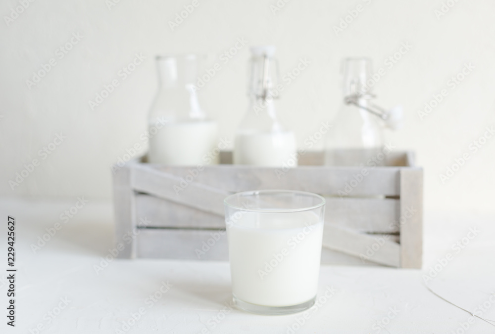 Milk in bottles on white background, kitchen Milk in bottles on white background, kitchen