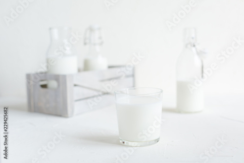 Milk in bottles on white background, kitchen