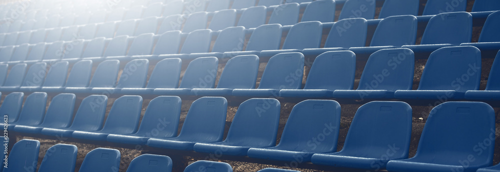 Naklejka premium Dark blue rows of seats on the stadium banner