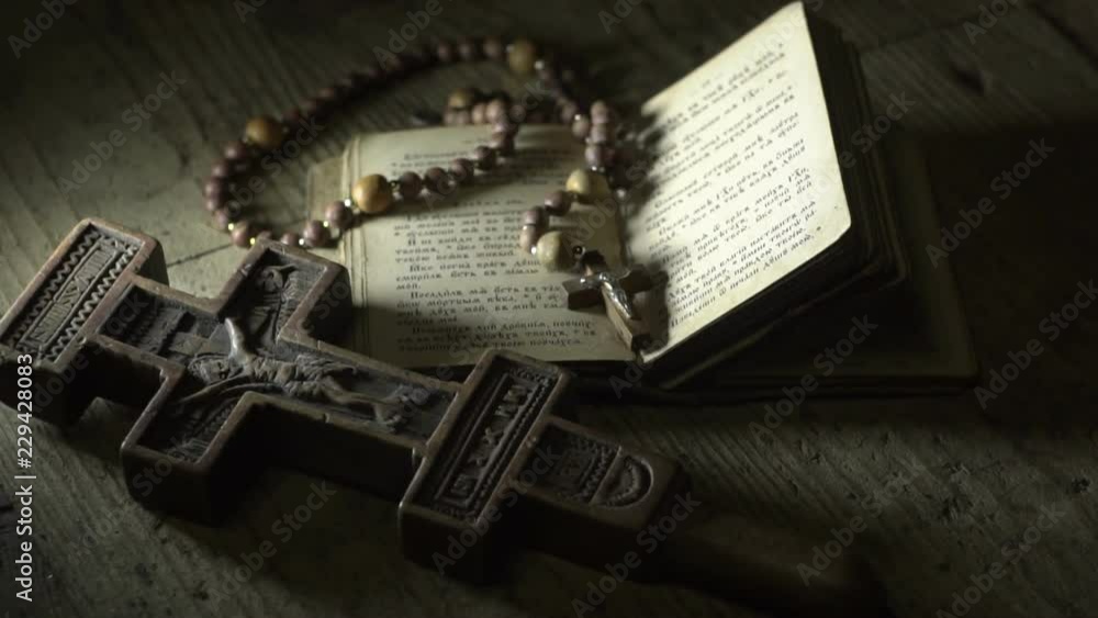 old prayer book rosary and old wooden cross in the dark old prayer book rosary and old wooden cross in the dark