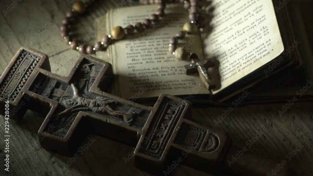 old prayer book rosary and old wooden cross in the dark old prayer book rosary and old wooden cross in the dark