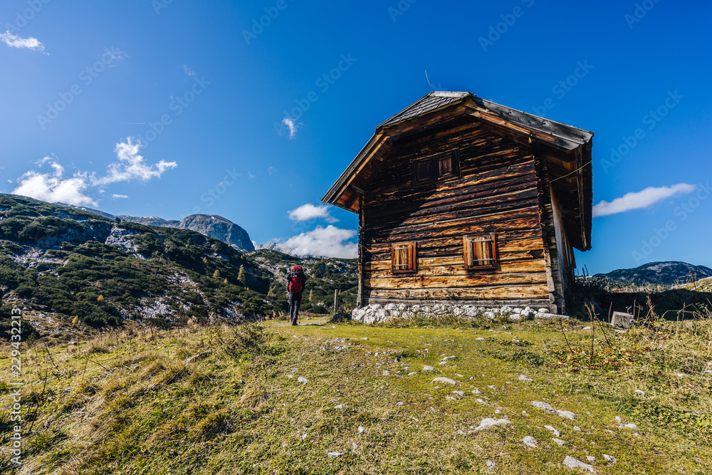 Hikers and trekkers in high alpine landscape, summer or autumn hiking in alpine mountain area. Blue sky, group of people with backpack on a hiking path. Dachstein gebirge, Austria.. Hikers and trekkers in high alpine landscape, summer or autumn hiking in alpine mountain area. Blue sky, group of people with backpack on a hiking path. Dachstein gebirge, Austria..