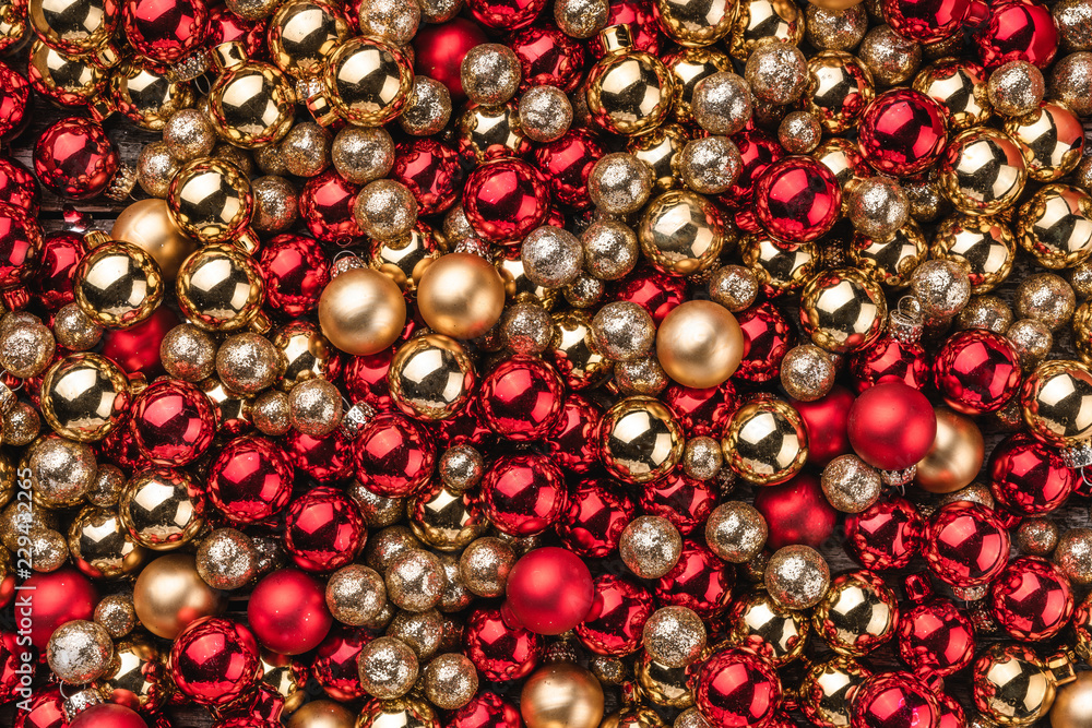 Christmas card. Wallpaper of red and gold baubles. Top view. Christmas card. Wallpaper of red and gold baubles. Top view.