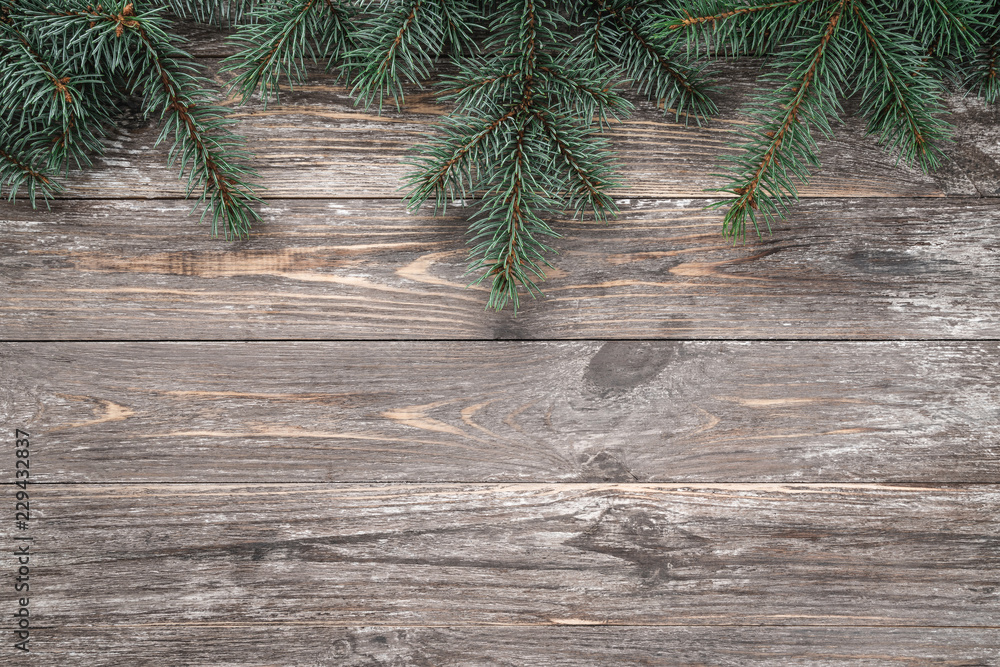 Old wood background with fir branches. Space for a greeting message. Christmas card. Top view.