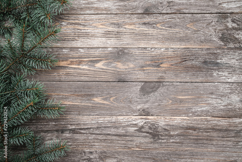 Old wood background with fir branches. Space for a greeting message. Christmas card. Top view.