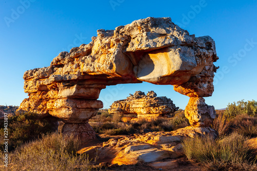 Rock arch against a clear blue sky near Kagga Kamma nature reserve in South Africa photo
