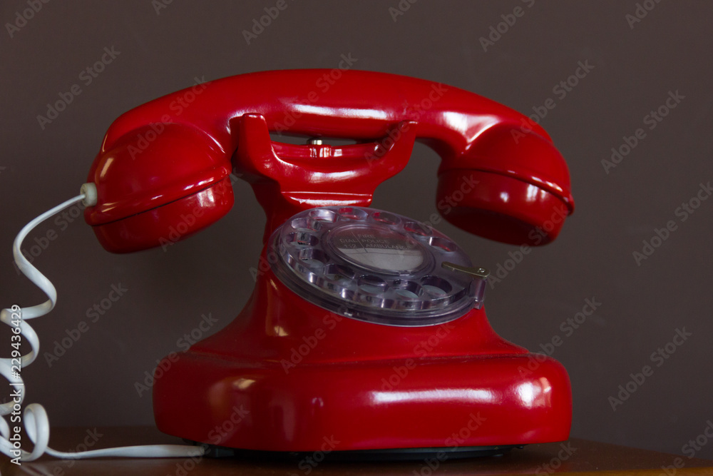 Retro style red telephone. Classic table phone with white cord.  Communication, call service, dial, vintage, old fashioned, antique  technology concepts Stock Photo | Adobe Stock