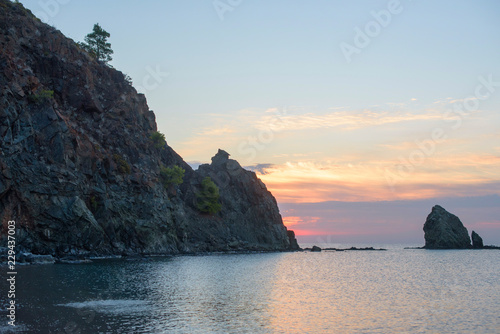 beautiful view of the rocks in the sea at dawn