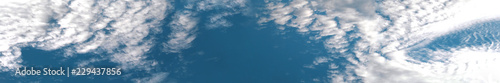 Cumulus clouds on a bright blue sky. Sunny weather. Selective focus, place for text. Banner