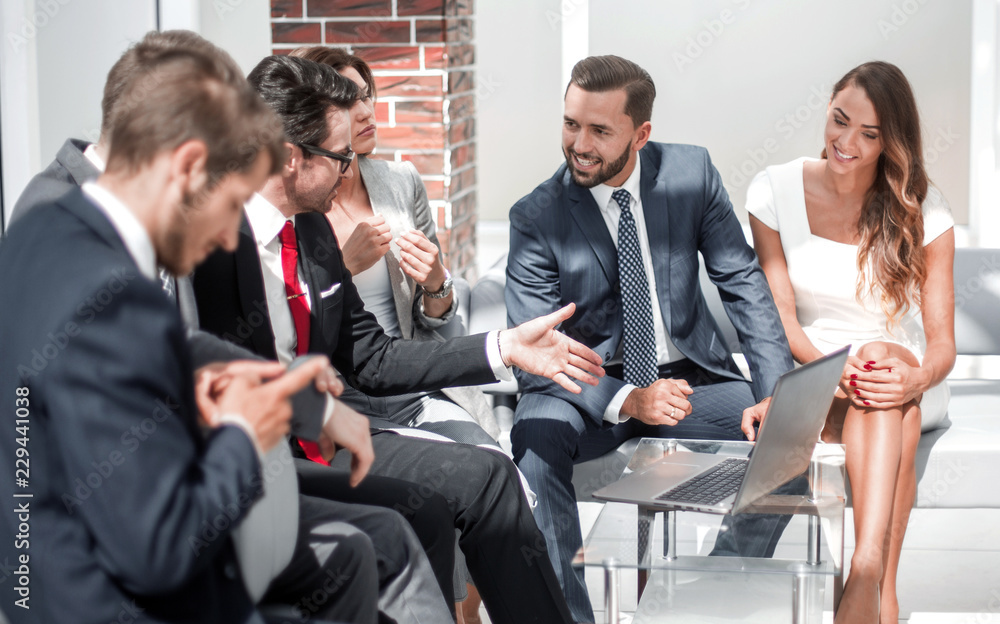 business team discussing business issues in the lobby of the business center.