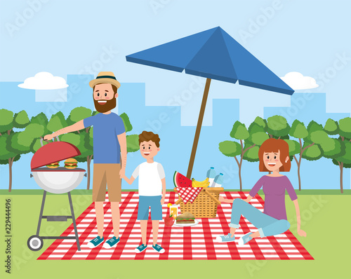 family picnic with umbrella and basket with fruit