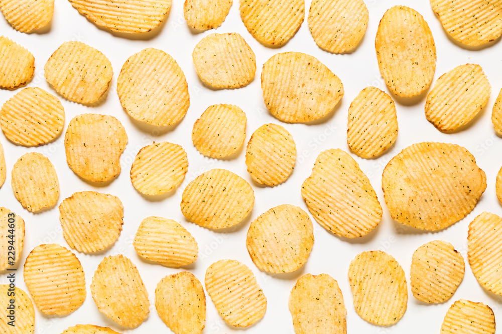 Crispy potatoes chips isolated on white background. Food background