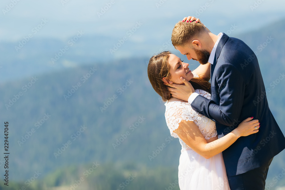 gentle hugs of newlyweds, they stand face to face and the bride closed her eyes gentle hugs of newlyweds, they stand face to face and the bride closed her eyes
