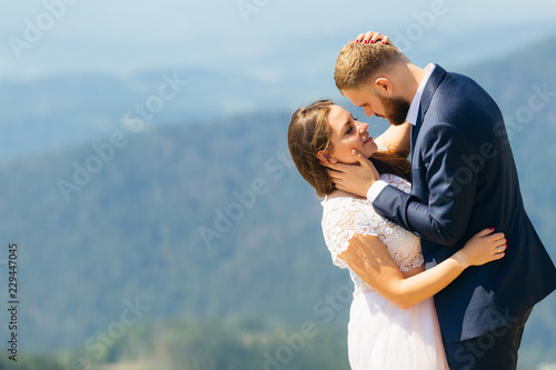 gentle hugs of newlyweds, they stand face to face and the bride closed her eyes