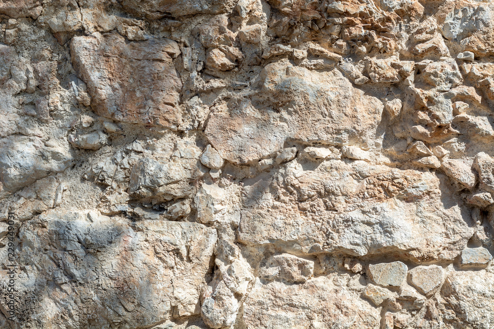 Bright stone wall texture background closeup, fragment from fort in Alanya, Turkey Bright stone wall texture background closeup, fragment from fort in Alanya, Turkey