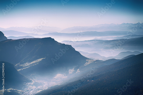 The magic of the mountains. View of the Val Gardena Valley from the top of the Seceda. Autumn haze in the Dolomites. The Dolomite Alps are a UNESCO World Heritage site. Ortisei town.