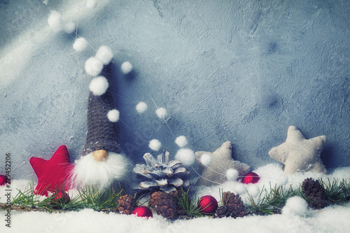 Cute Christmas gnome in abstract winter landscape photo