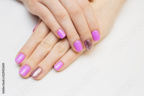 Nails varnishing in white color. Manicure  pedicure beauty salon concept. Empty place for text or logo.
