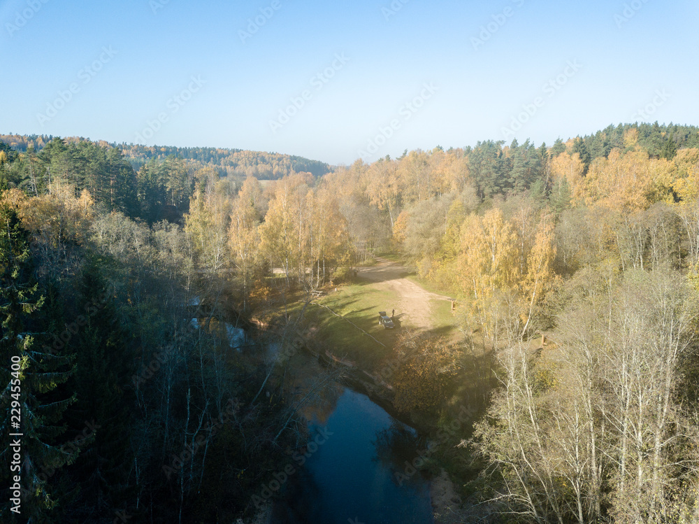 drone image. aerial view of wavy river in autumn colored forest drone image. aerial view of wavy river in autumn colored forest