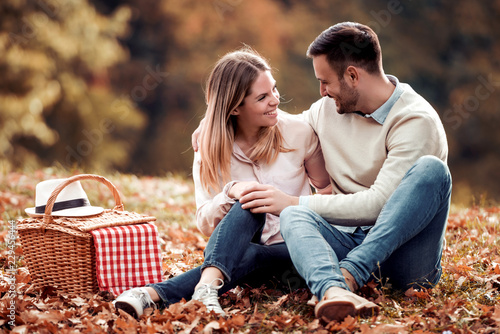 Couple in love sitting in autumn park