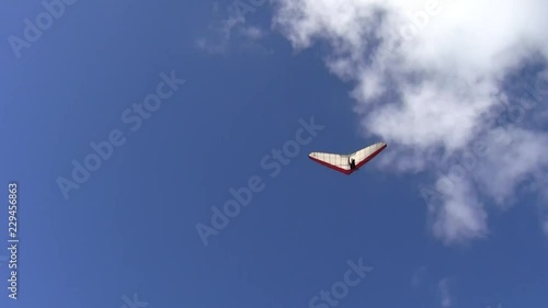 Hanggliders launching from a perch or towed by small motorized air craft. Hanggliders flying