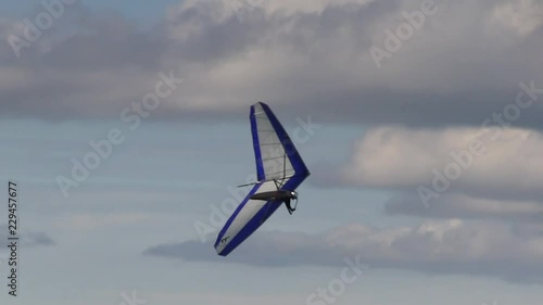 Hanggliders launching from a perch or towed by small motorized air craft. Hanggliders flying