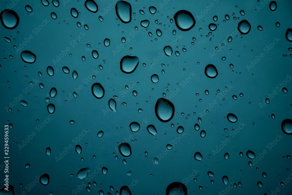 CLOSE UP IMAGE OF RAIN DROPS ON GLASS WINDOW CLOSE UP IMAGE OF RAIN DROPS ON GLASS WINDOW