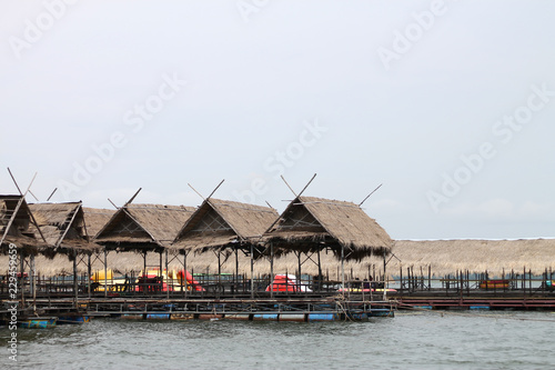 Wooden floating raft house in river at Sirintorn dam Ubonratchatani,Thailand. © pichai