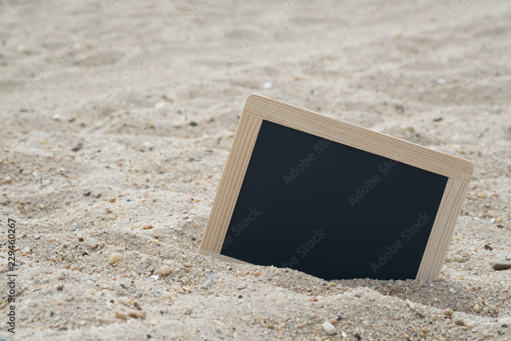 Fotografie BLANK CHALKBOARD ON THE SAND