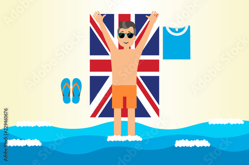 Man on British flag tower on sand
