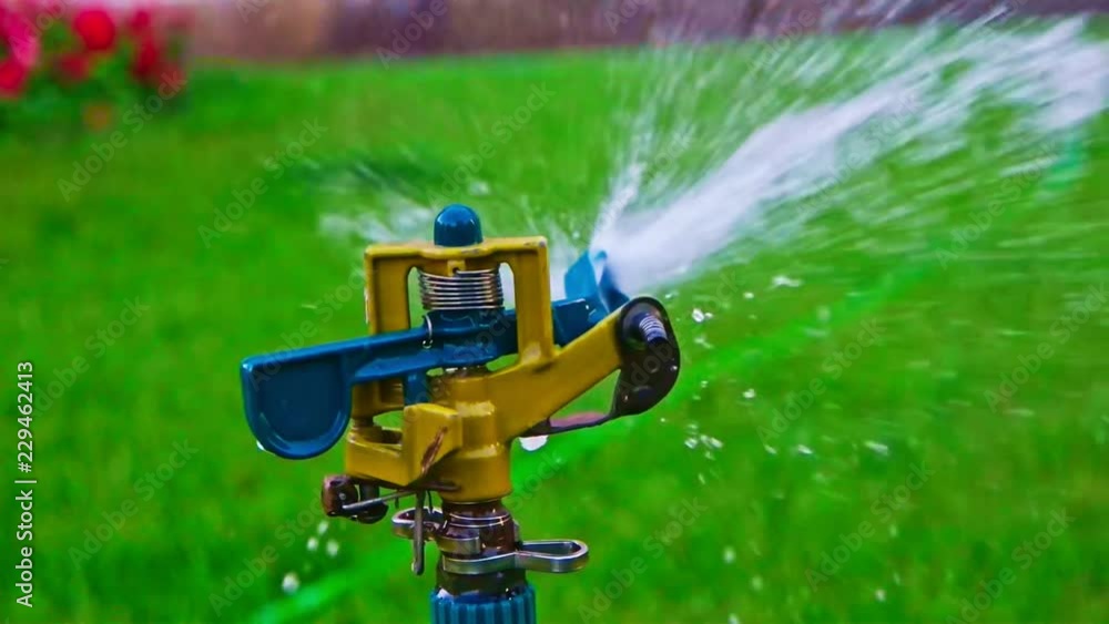 Head of garden sprinkler spreading watr around Head of garden sprinkler spreading watr around