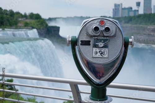 COIN OPERATED BINOCULAR FOR TOURIST WITH BACKGROUND OF NIAGARA FALLS. NEW YORK, USA.