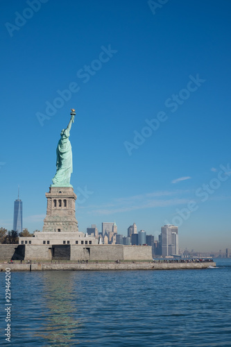 STATUE OF LIBERTY WITH ONE WORLD TRADE CENTER AND SKYSCRAPERS IN THE BACKGROUND / LOWER MANHATTAN / NEW YORK CITY © DoubletreeStudio