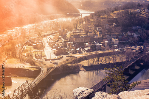 VIEW OF HARPERS FERRY NATIONAL HISTORICAL PARK, WEST VIRGINIA, USA WITH EVENING LIGHT AND FOG OVER THE RIVER IN VINTAGE TONE photo